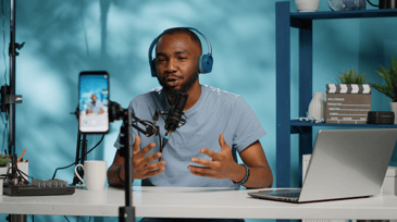 Man recording a video job description with a camera, showcasing personal engagement in the hiring process