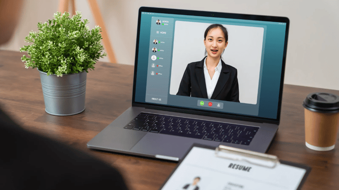 A woman recording a video job description with a camera, showcasing personal engagement in the hiring process