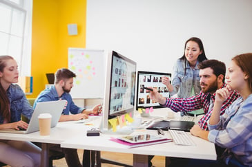 young professionals working in an office environment on computers