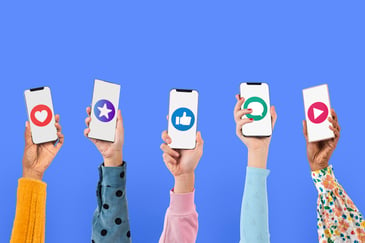 hands holding up cell phones with socialmedia icons on them