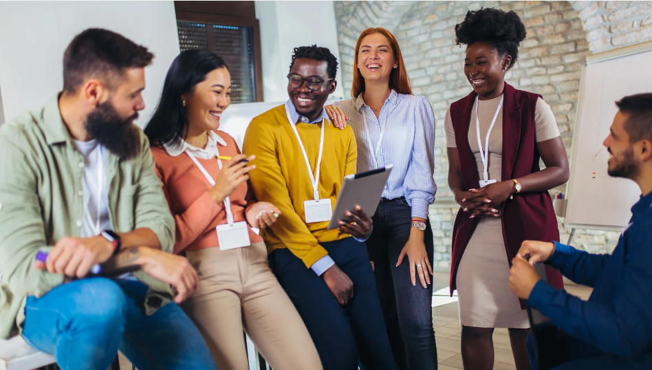 a diverse group of people in a workplace setting, smiling and collaborating